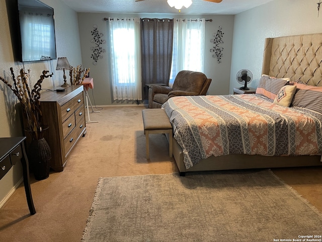 bedroom with light carpet, ceiling fan, and multiple windows