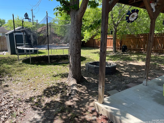 view of yard with a storage unit and a trampoline