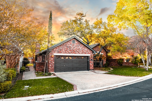 view of front of home with a garage and a lawn