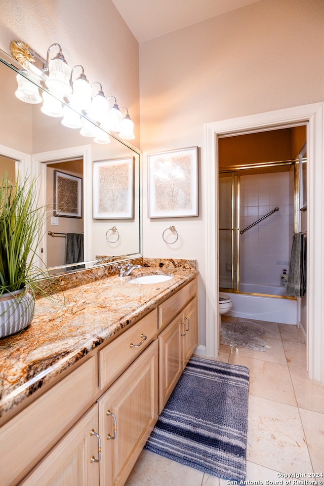 full bathroom featuring toilet, tile flooring, tiled shower / bath combo, and vanity