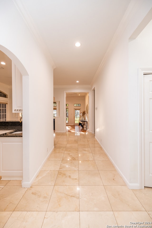 hall featuring ornamental molding and light tile floors