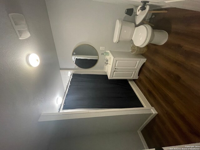 bathroom featuring vanity, toilet, and hardwood / wood-style flooring