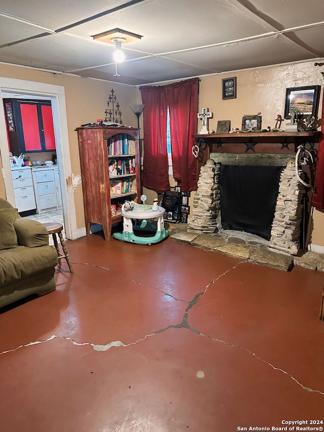 living room featuring a fireplace and finished concrete flooring