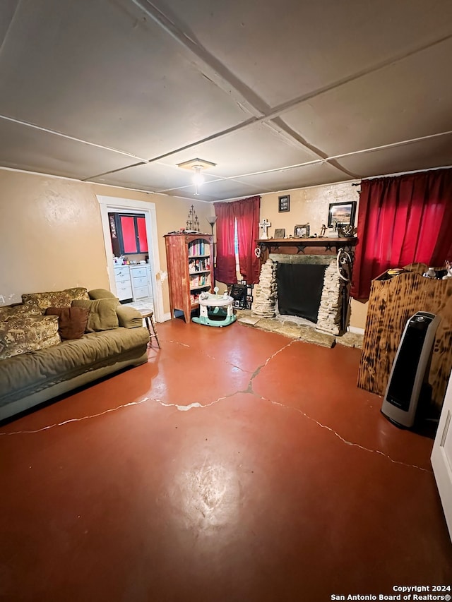 living room featuring a fireplace and concrete flooring