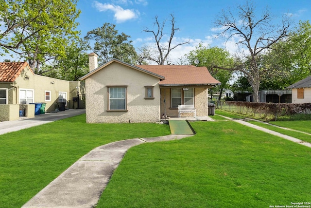 bungalow-style home with a front yard