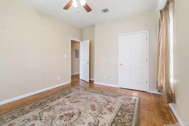 unfurnished bedroom featuring ceiling fan and dark wood-type flooring