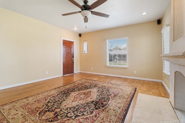 living room featuring ceiling fan and light hardwood / wood-style floors