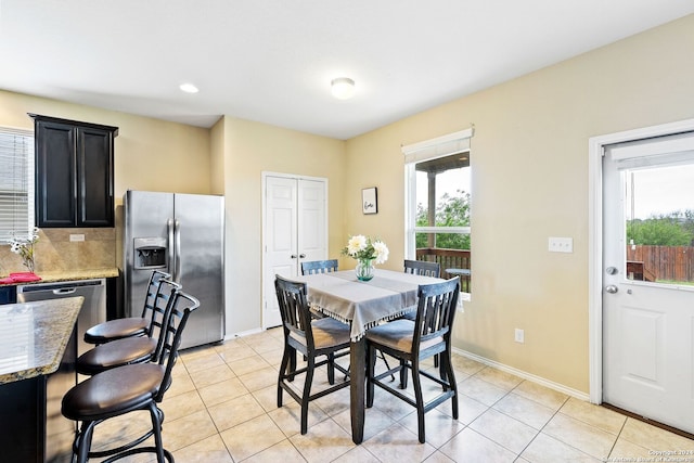 dining space with light tile floors