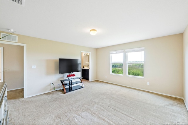 unfurnished living room featuring light carpet