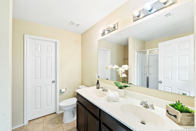 bathroom featuring dual vanity, tile floors, and toilet