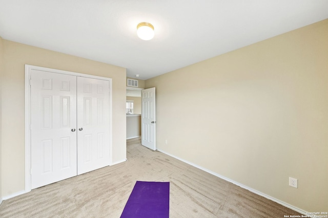 interior space featuring a closet and light colored carpet