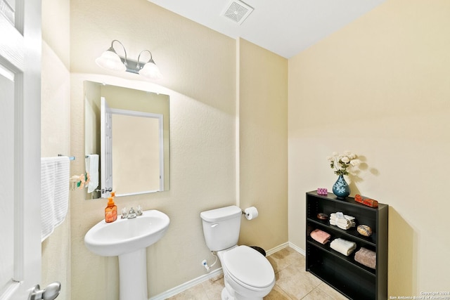 bathroom featuring tile floors and toilet