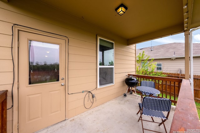 view of exterior entry with a patio