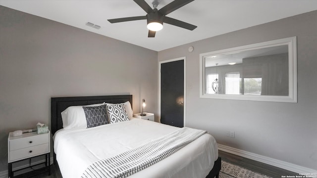 bedroom with ceiling fan and dark hardwood / wood-style floors