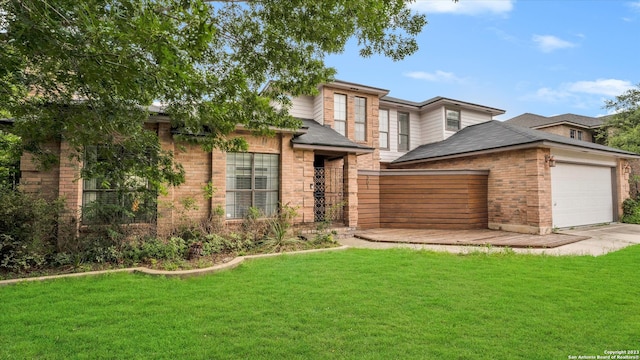 view of front of home with a front lawn and a garage