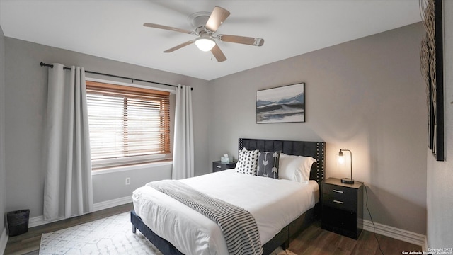 bedroom with ceiling fan and dark wood-type flooring