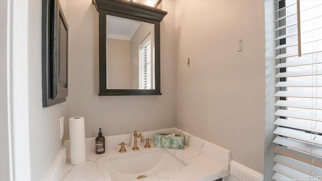 bathroom with radiator heating unit, sink, and ornamental molding