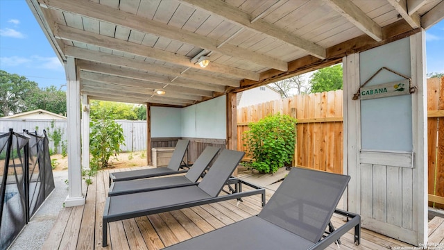 wooden terrace featuring an outdoor structure