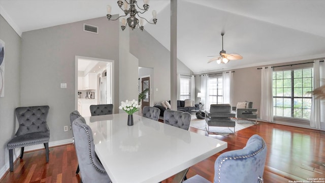 dining space featuring lofted ceiling, ceiling fan with notable chandelier, and dark hardwood / wood-style flooring