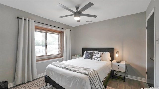 bedroom with ceiling fan and dark wood-type flooring