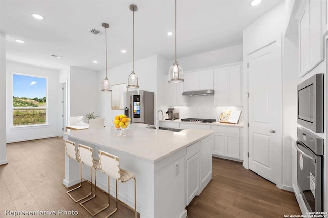 kitchen featuring light hardwood / wood-style flooring, white cabinetry, stainless steel appliances, sink, and tasteful backsplash