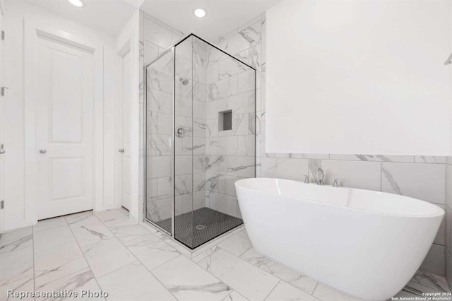 bathroom with tile walls, plus walk in shower, and tile flooring