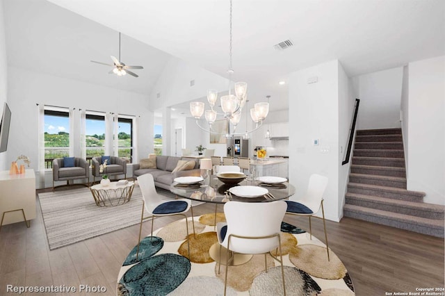 interior space with ceiling fan with notable chandelier, high vaulted ceiling, hardwood / wood-style flooring, and french doors