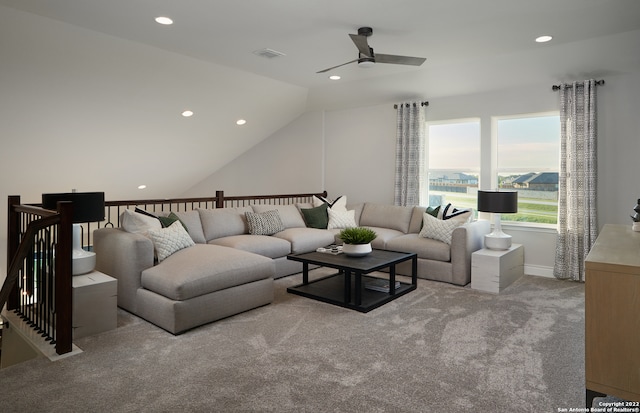 carpeted living room with lofted ceiling and ceiling fan