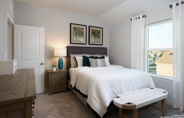 carpeted bedroom featuring lofted ceiling