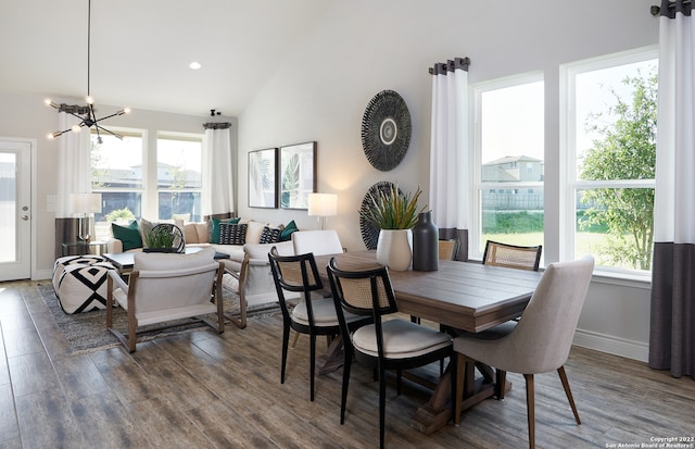 dining room featuring lofted ceiling, dark hardwood / wood-style floors, and an inviting chandelier