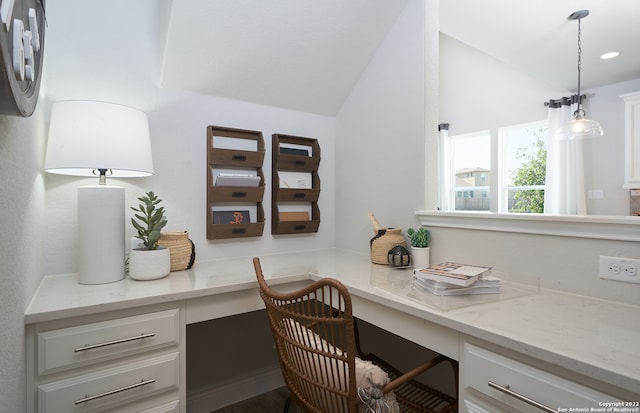 office area with lofted ceiling and built in desk