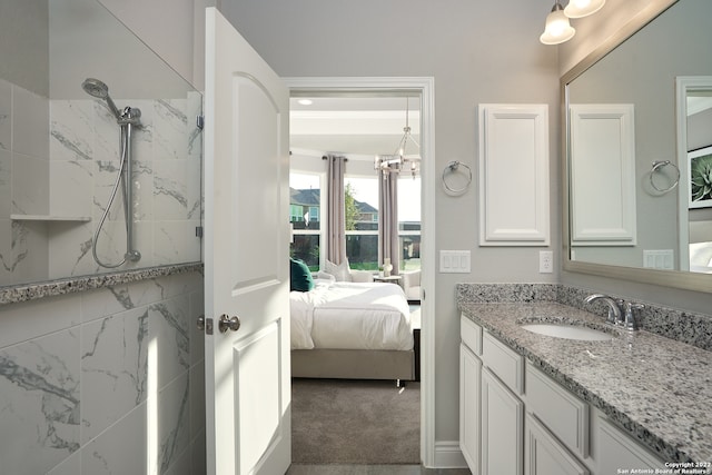 bathroom with an inviting chandelier and large vanity