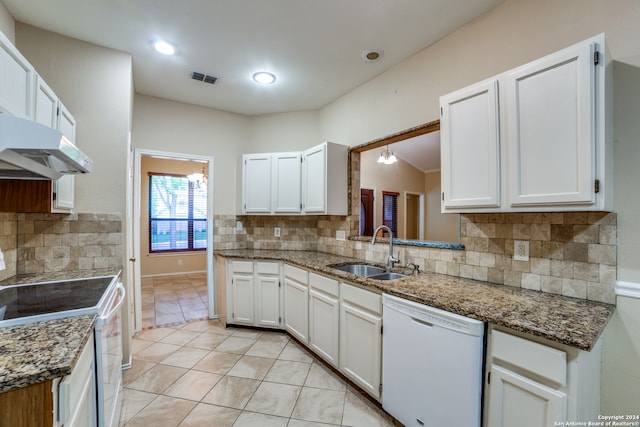 kitchen with backsplash, dark stone countertops, white cabinets, and white appliances