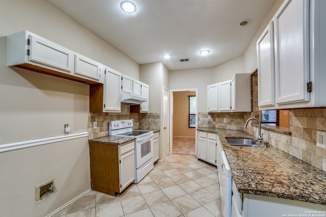 kitchen with white cabinetry, dark stone counters, white appliances, and sink