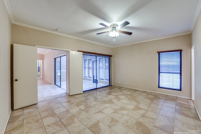 tiled spare room featuring ornamental molding, a healthy amount of sunlight, and ceiling fan