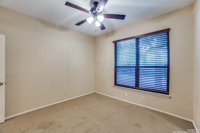 unfurnished room featuring light carpet and ceiling fan