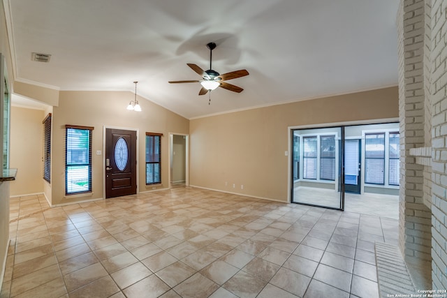 tiled empty room featuring ceiling fan with notable chandelier, crown molding, and lofted ceiling