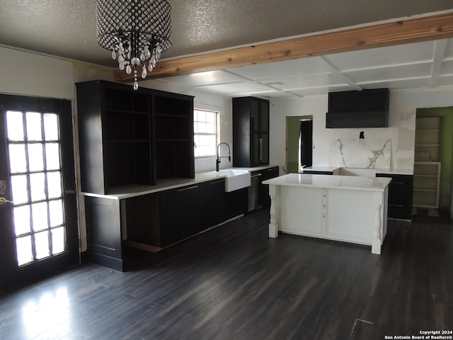 kitchen featuring a notable chandelier, a kitchen island, dark wood-type flooring, and sink