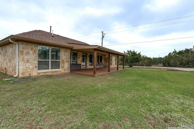 back of house with a lawn and a patio area