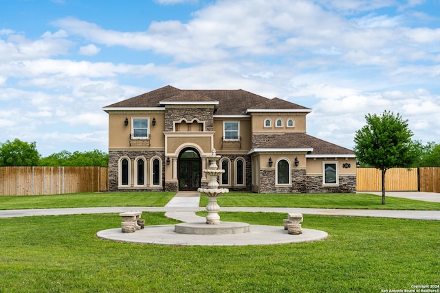 mediterranean / spanish-style house featuring a front lawn