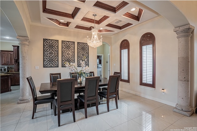 tiled dining room with coffered ceiling, crown molding, ornate columns, and an inviting chandelier