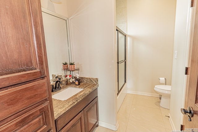 bathroom featuring toilet, tile floors, and vanity