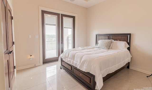 bedroom with access to exterior and light tile floors