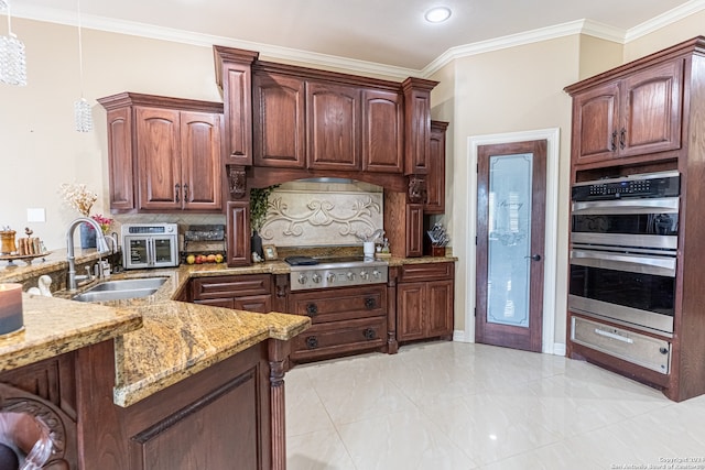 kitchen with light tile floors, appliances with stainless steel finishes, sink, hanging light fixtures, and light stone counters