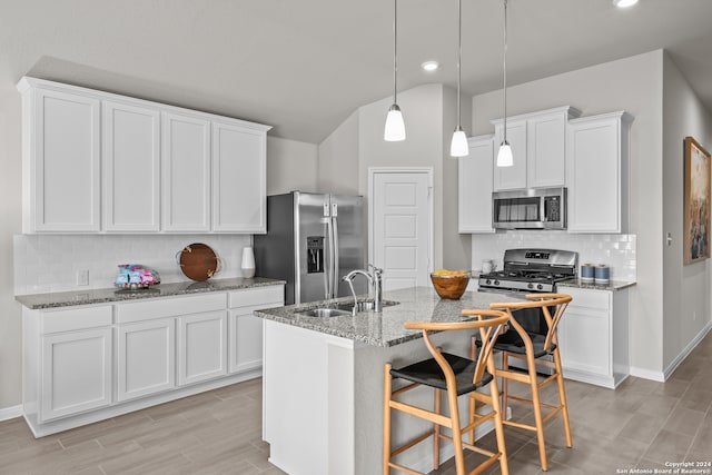 kitchen featuring white cabinetry, an island with sink, appliances with stainless steel finishes, and sink