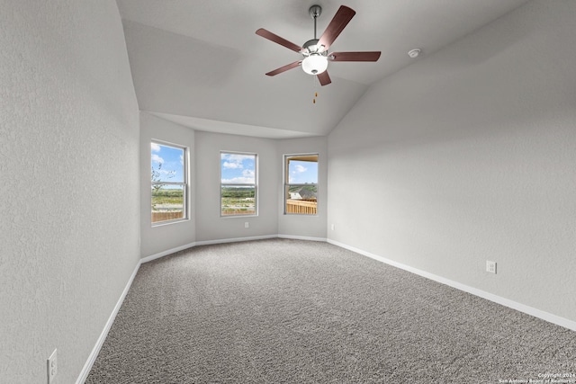 unfurnished room featuring lofted ceiling, carpet flooring, and ceiling fan