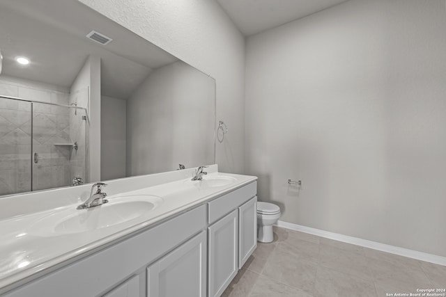 bathroom with vanity, a shower with shower door, tile patterned floors, and toilet