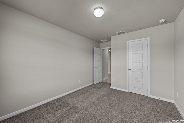 unfurnished bedroom with carpet and a textured ceiling