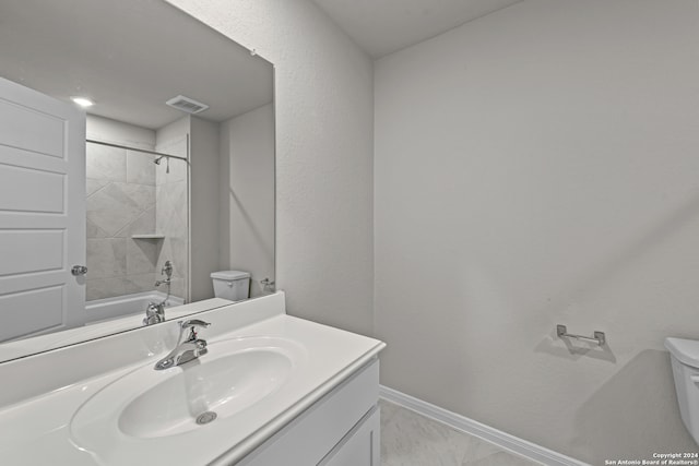 full bathroom with vanity, tiled shower / bath, and toilet