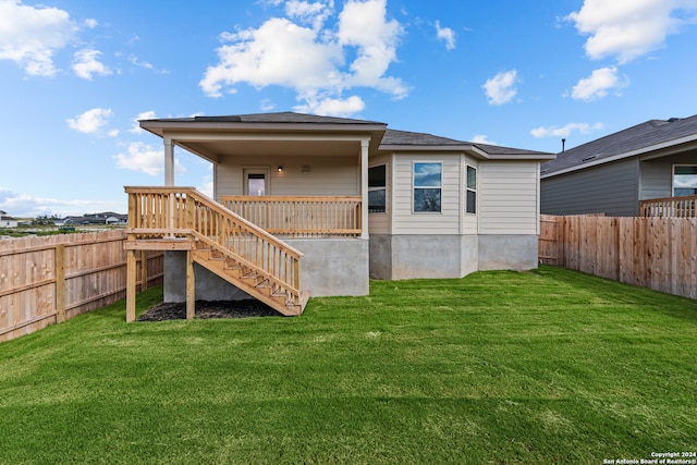 back of property featuring a lawn